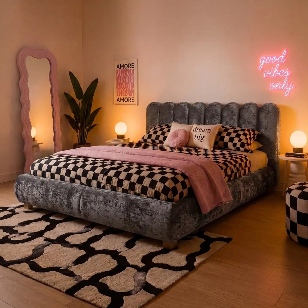 Dark gray velvet ottoman bed with tufted headboard, checkered duvet and blanket.